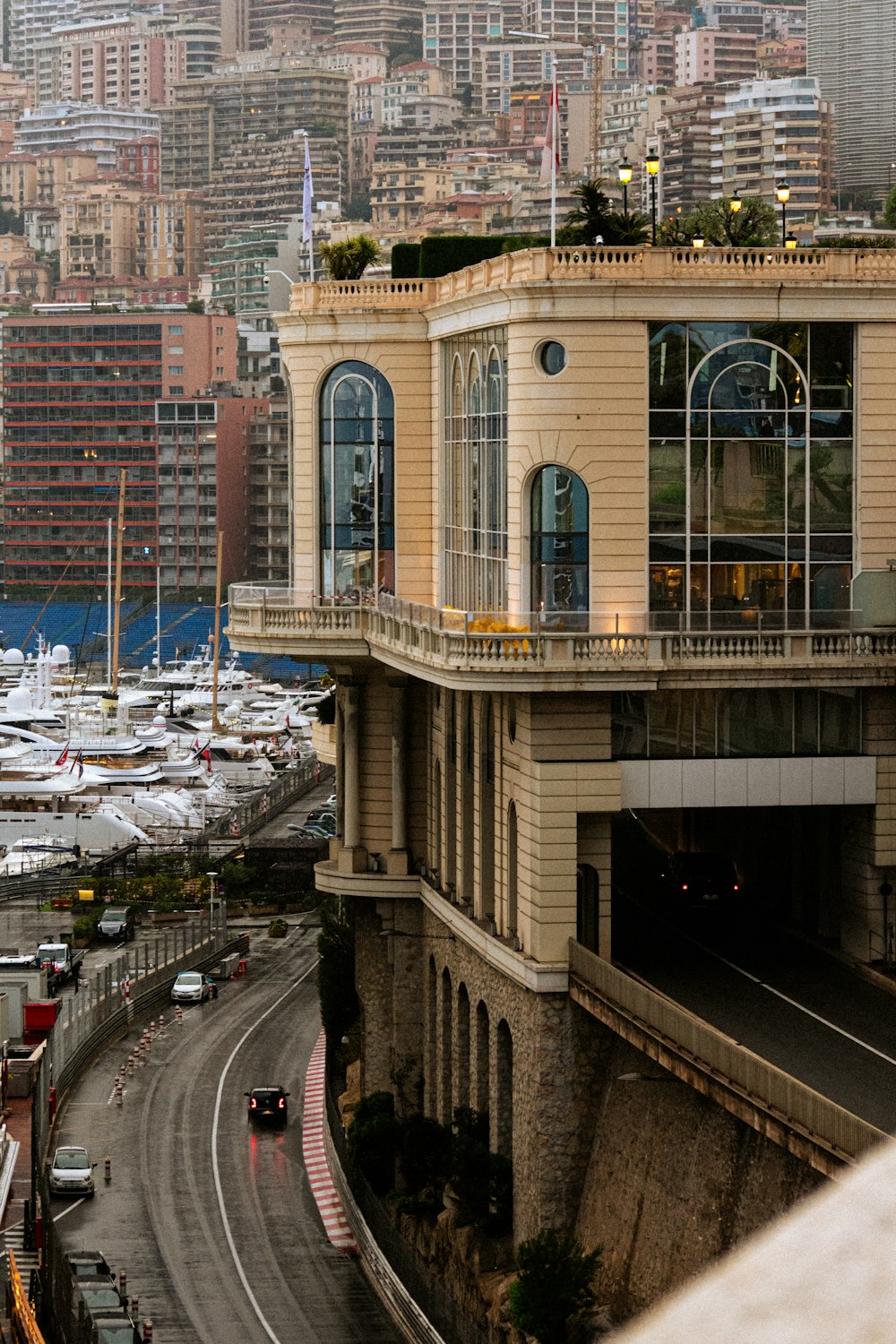 a very tall building sitting next to a harbor filled with lots of boats