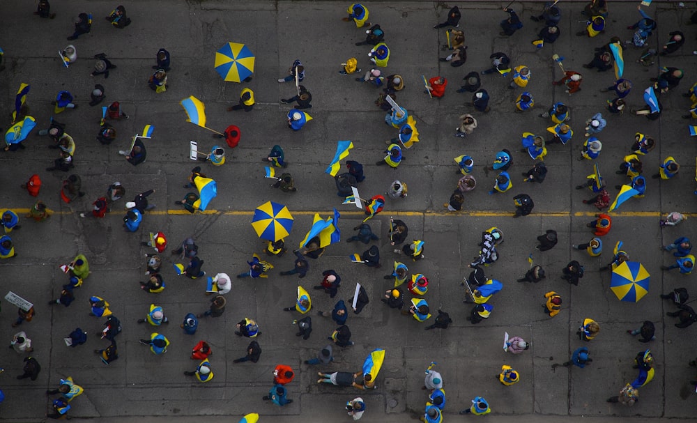 a group of people walking down a street holding umbrellas