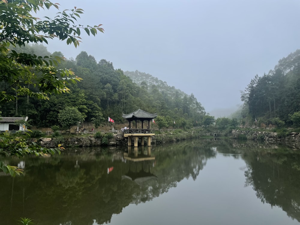 a lake with a pavilion in the middle of it