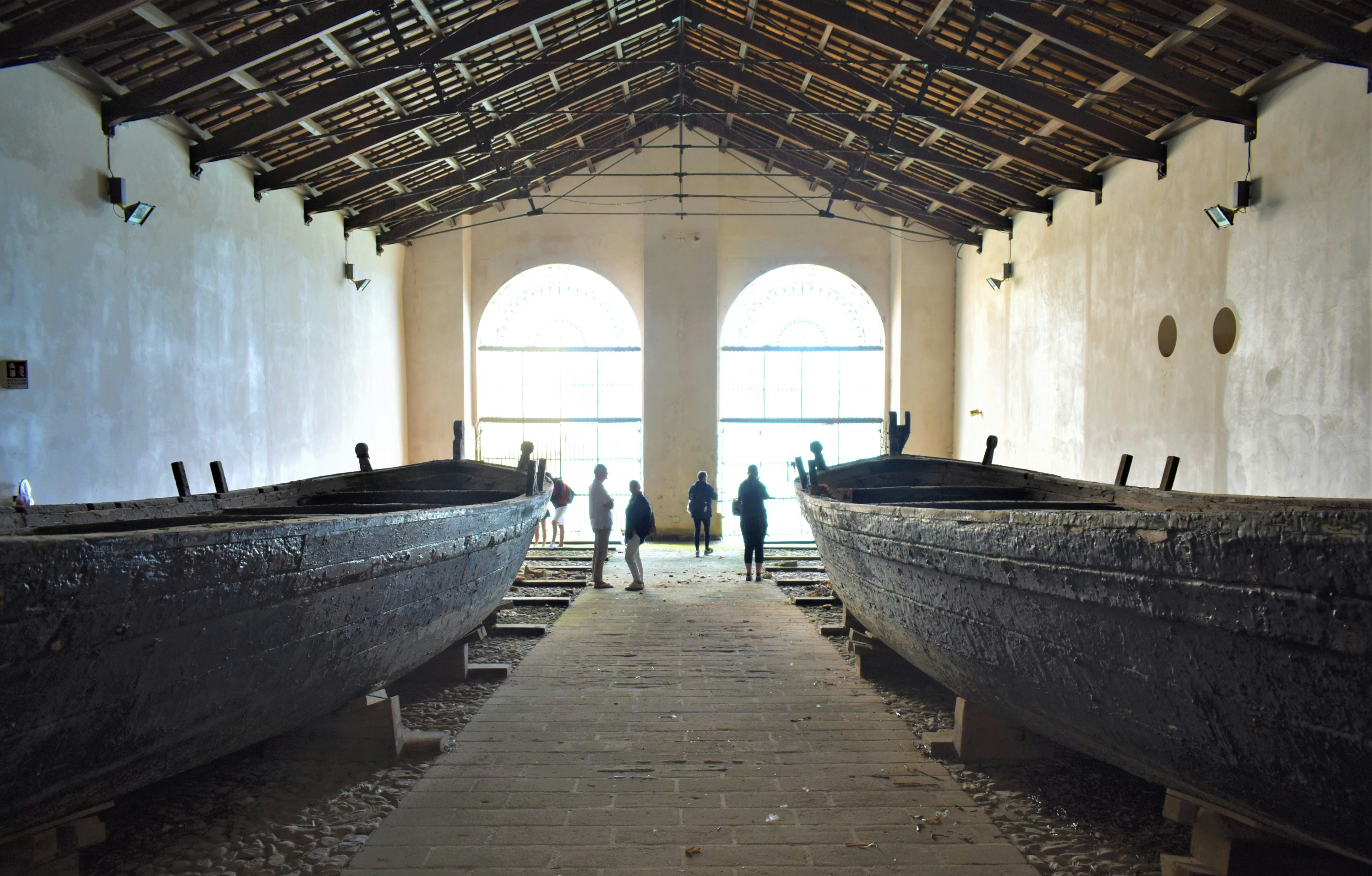 a group of people standing next to two large boats