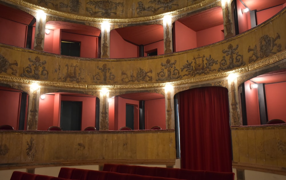 a circular room with a red curtain and red curtains