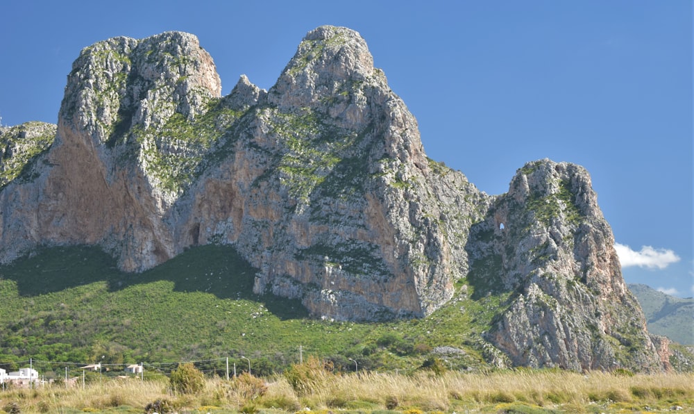 a mountain range with a house in the foreground