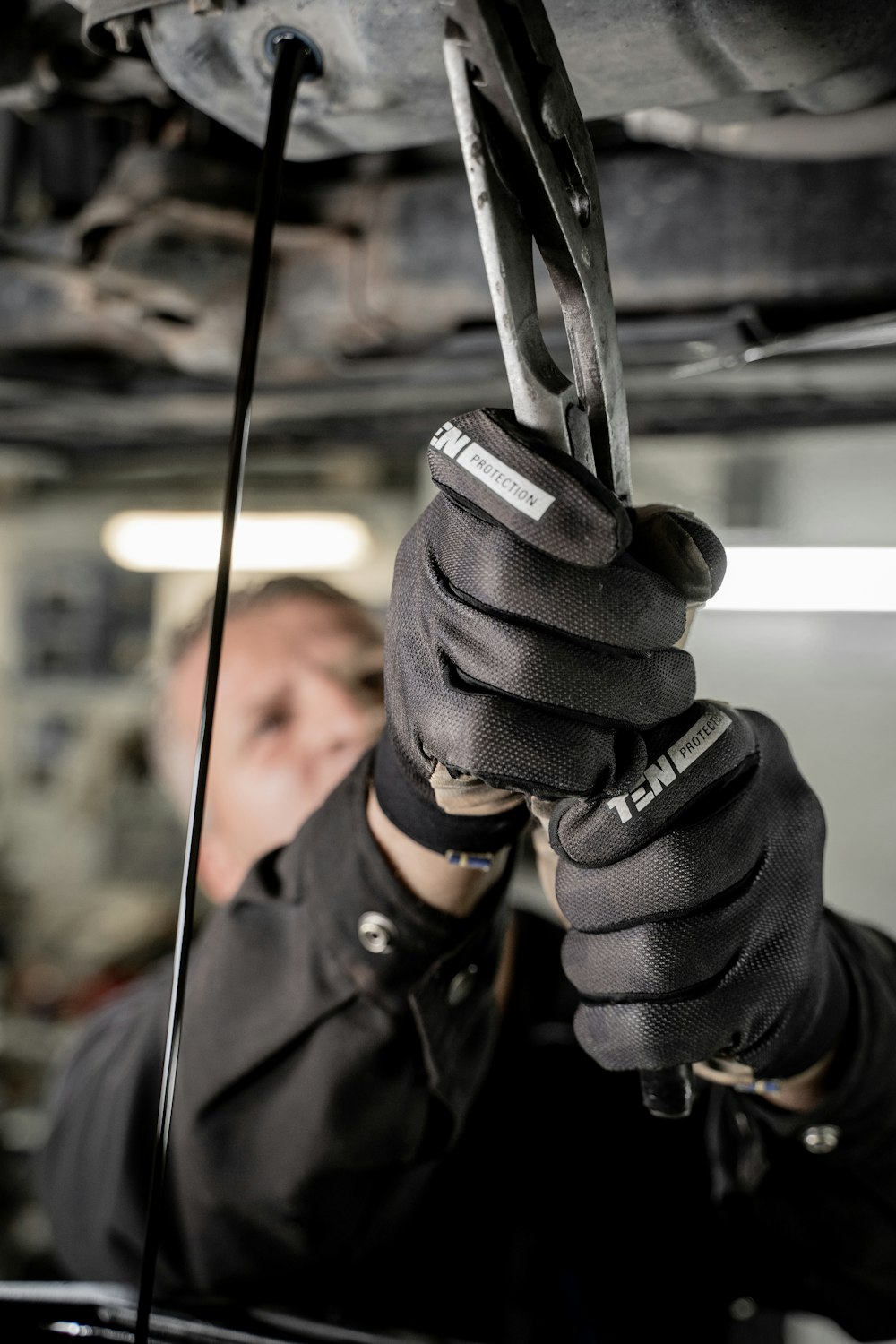 a man working on a vehicle with a wrench