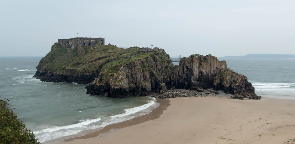 a beach with a small island in the middle of it