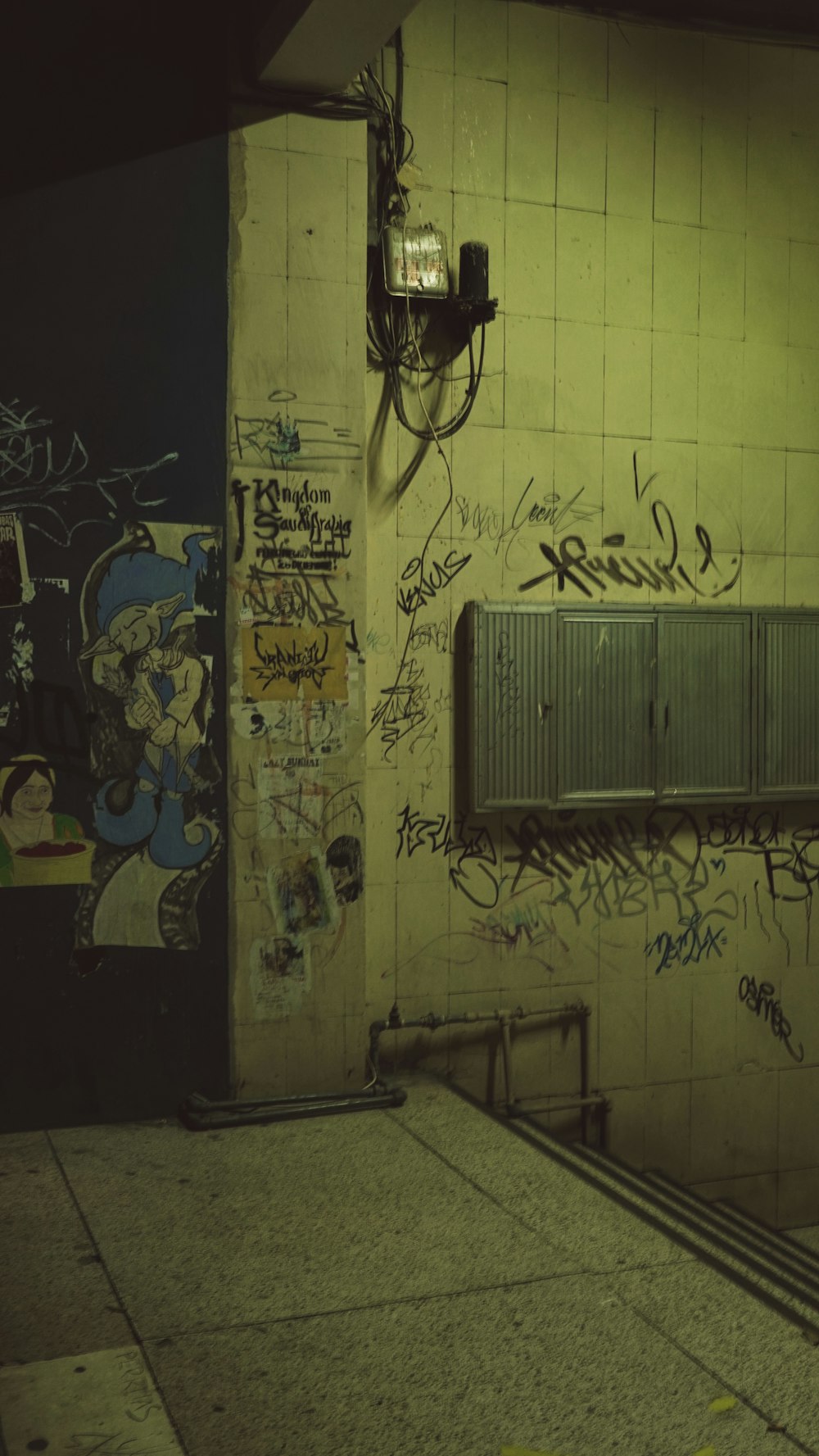 a bathroom with graffiti on the walls and a radiator