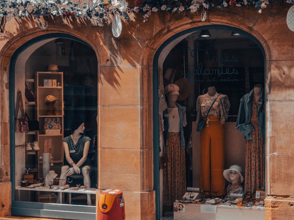 a store front with mannequins in the windows