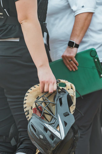 a close up of a person holding a catchers mitt