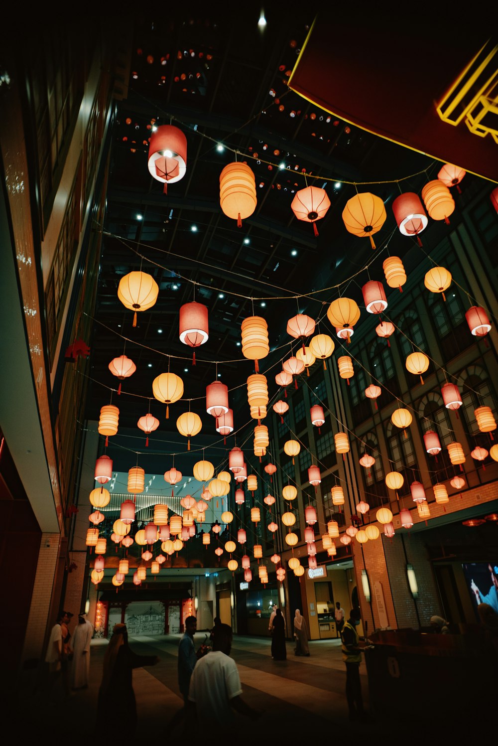 a large room filled with lots of paper lanterns