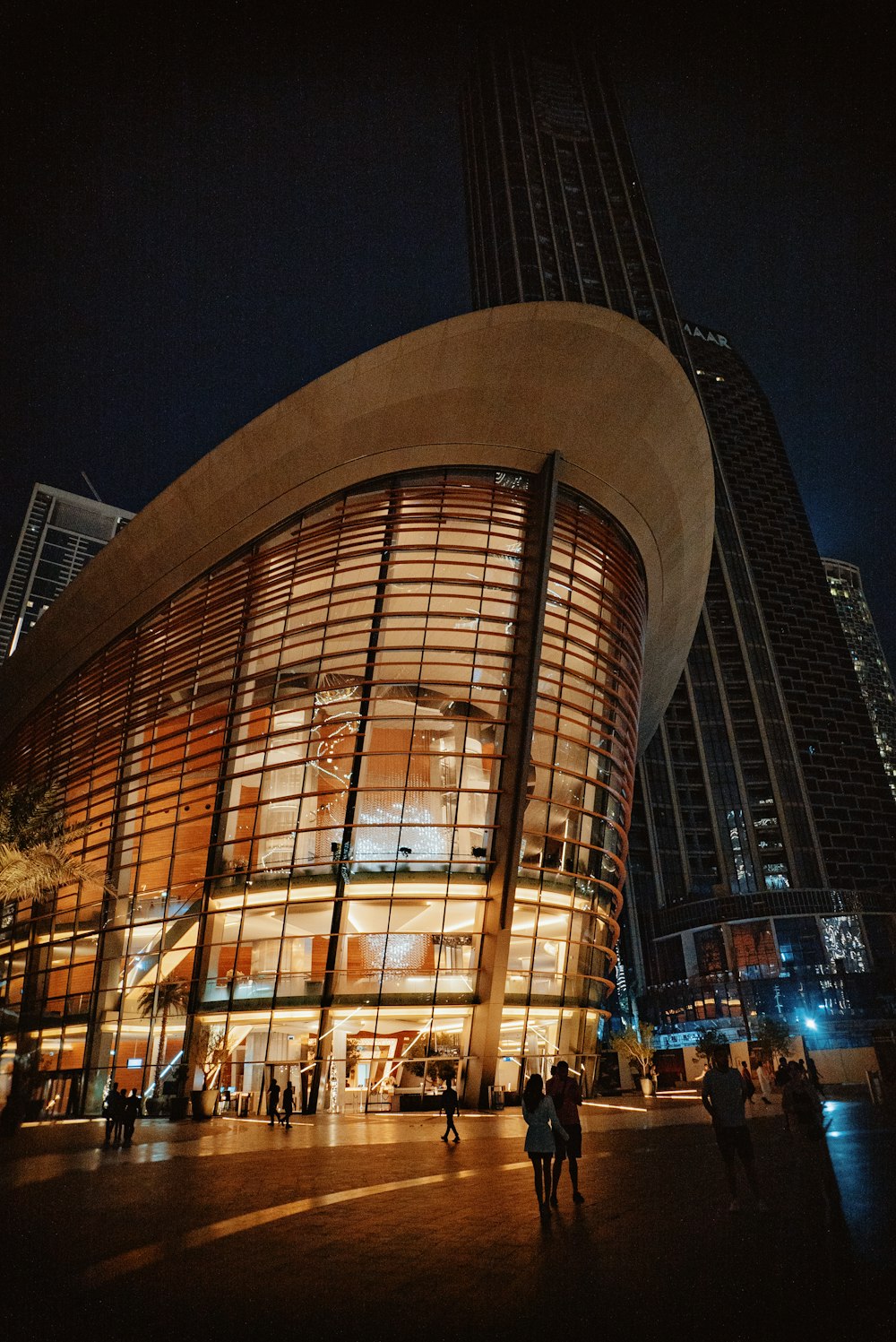 people are standing outside of a building at night