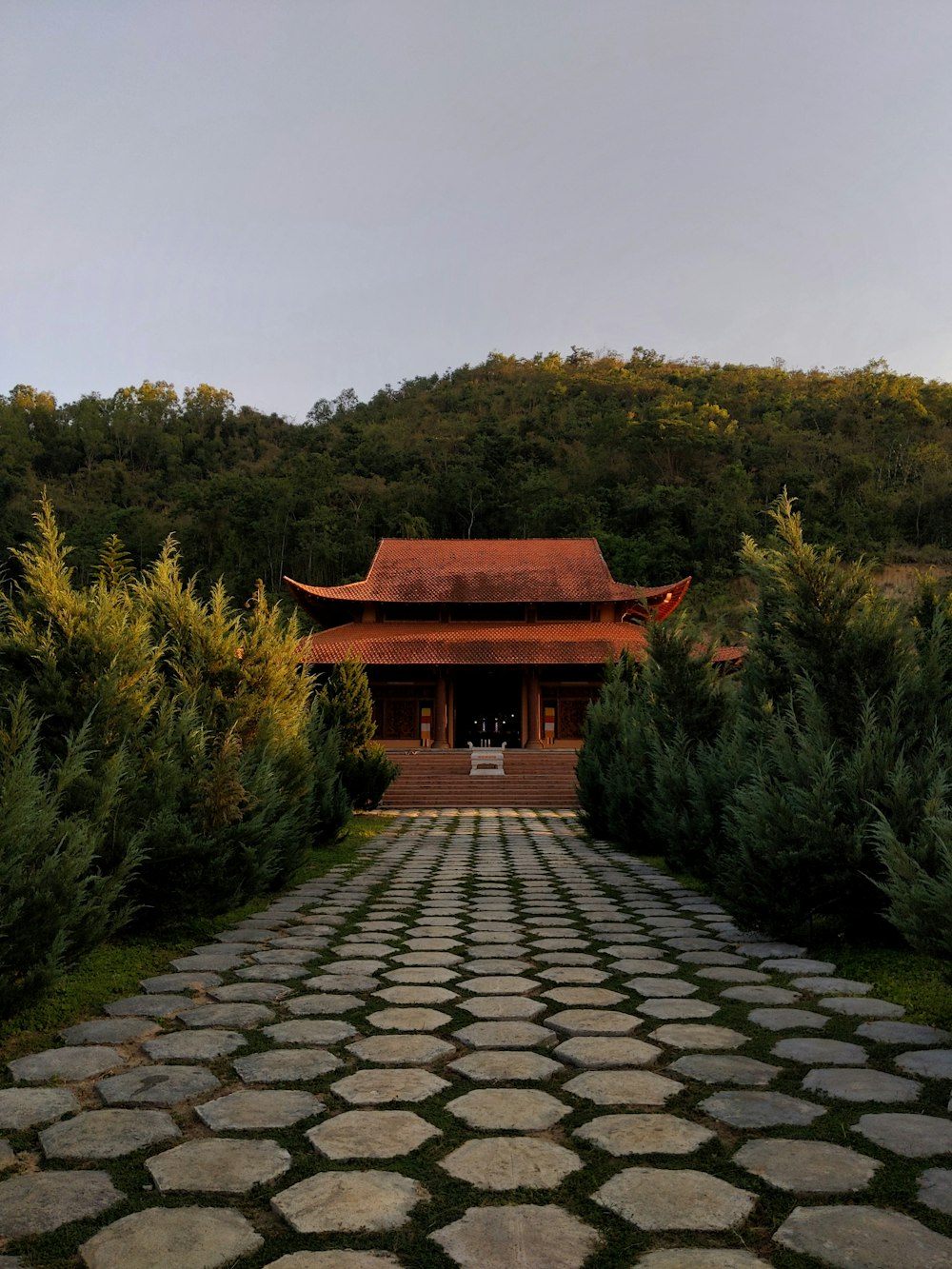 a stone walkway with a building in the background