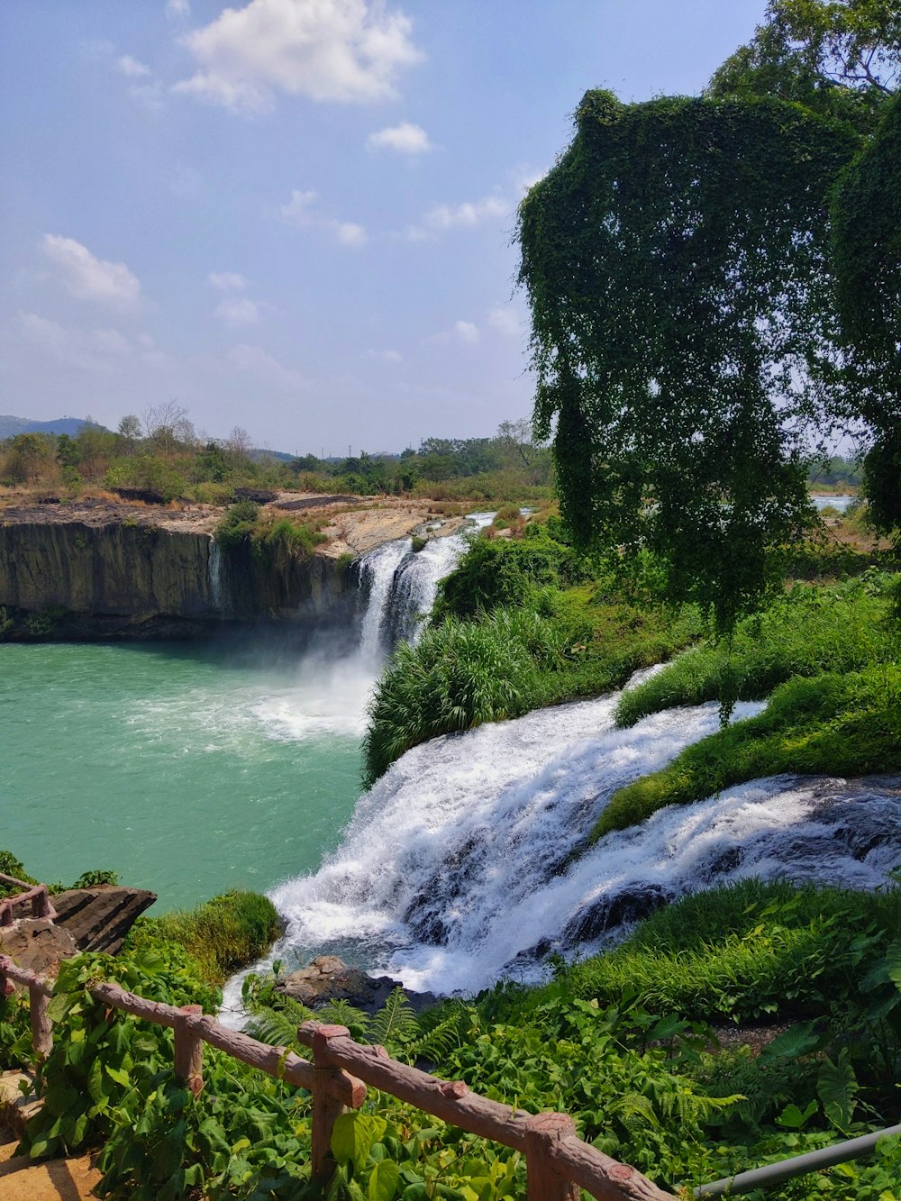 a view of a waterfall from a bridge