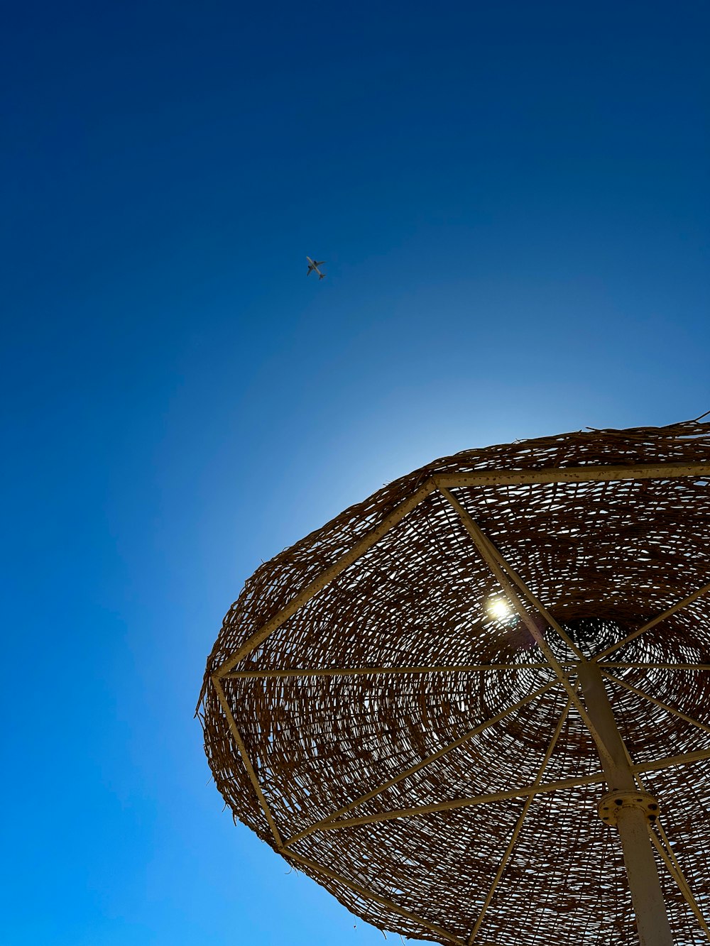 a beach umbrella with a clear blue sky in the background