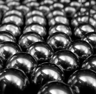 a bunch of shiny balls sitting on top of a table