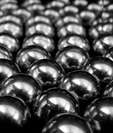 a bunch of shiny balls sitting on top of a table