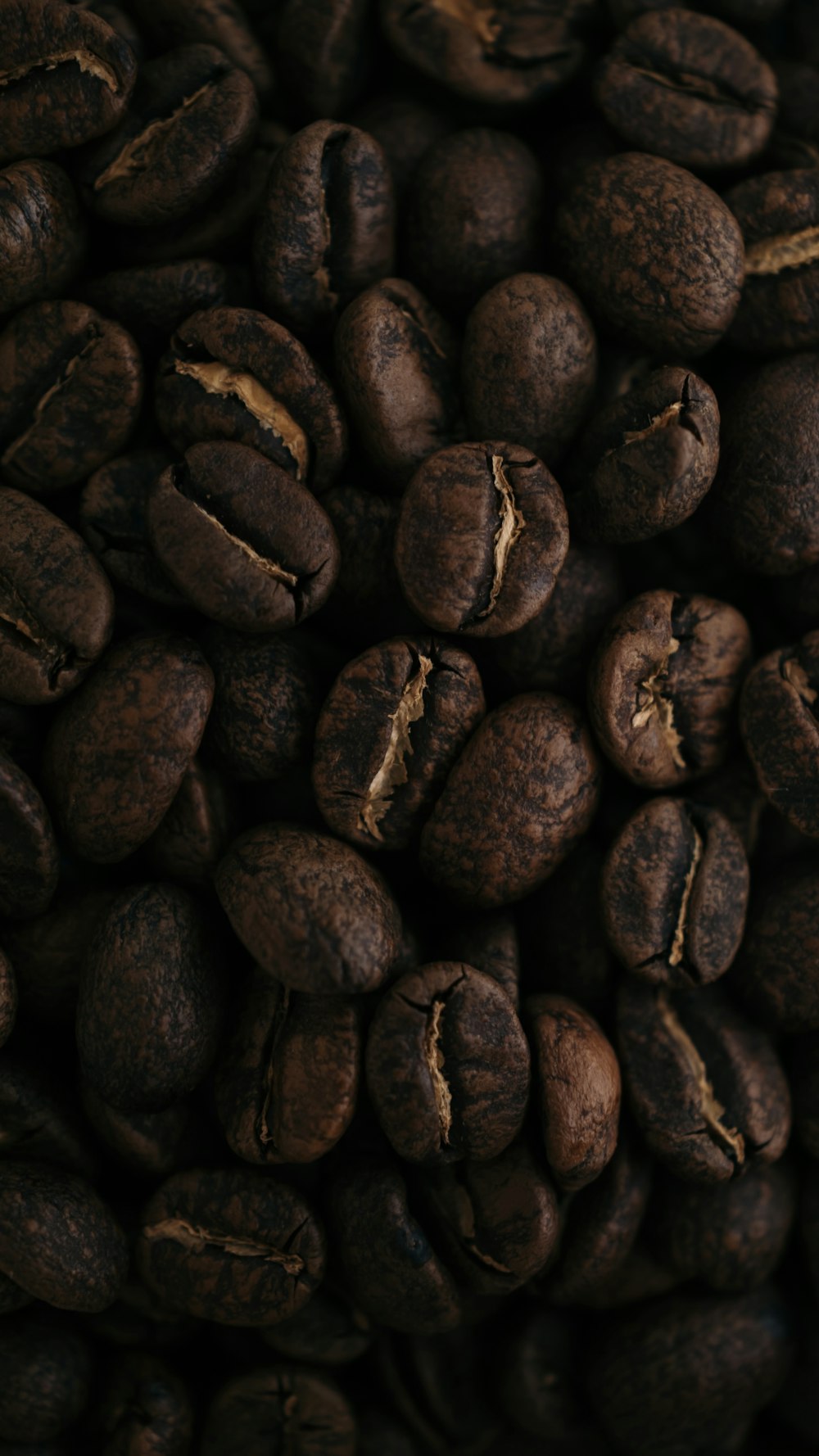 a pile of coffee beans that are brown