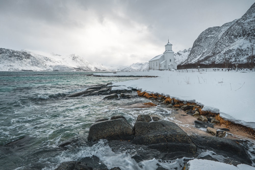 a snowy landscape with a church in the background