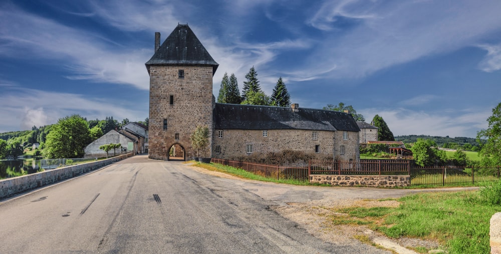 an old church sits on the side of a road