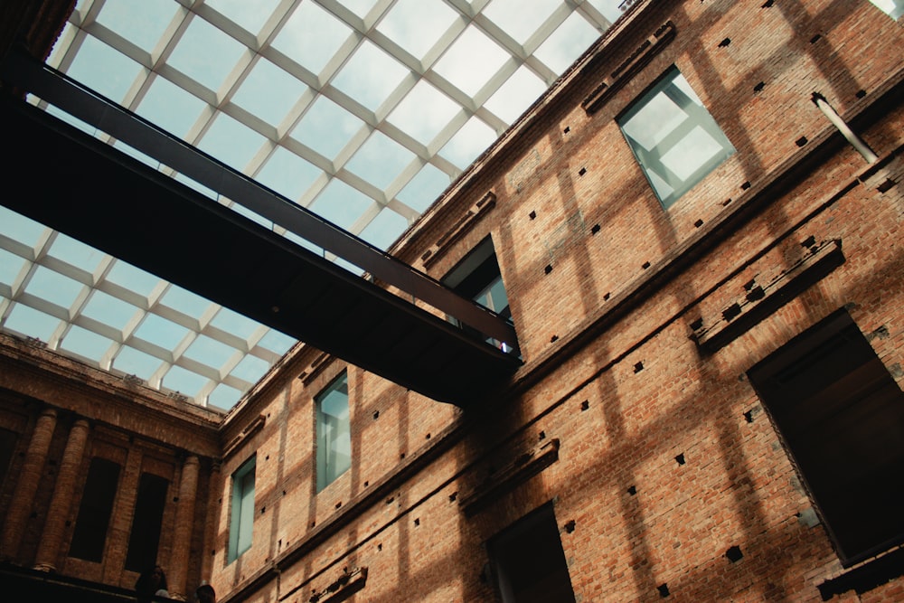 a brick building with a glass roof and a skylight