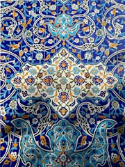 A vibrant display of Talavera tiles showcasing cobalt blue and white designs.