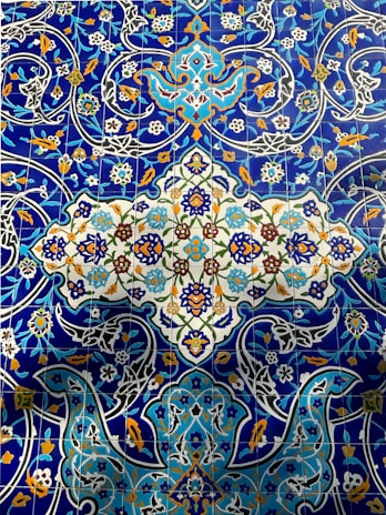 Vibrant blue and white ceramic tiles featuring Arabic calligraphy patterns.