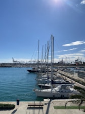 a marina filled with lots of boats under a blue sky