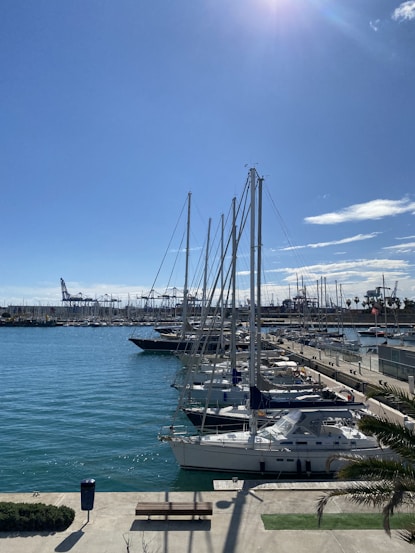 a marina filled with lots of boats under a blue sky
