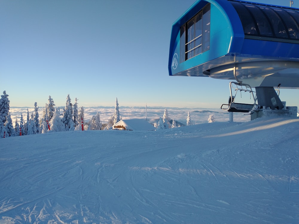 a ski lift sitting on top of a snow covered slope