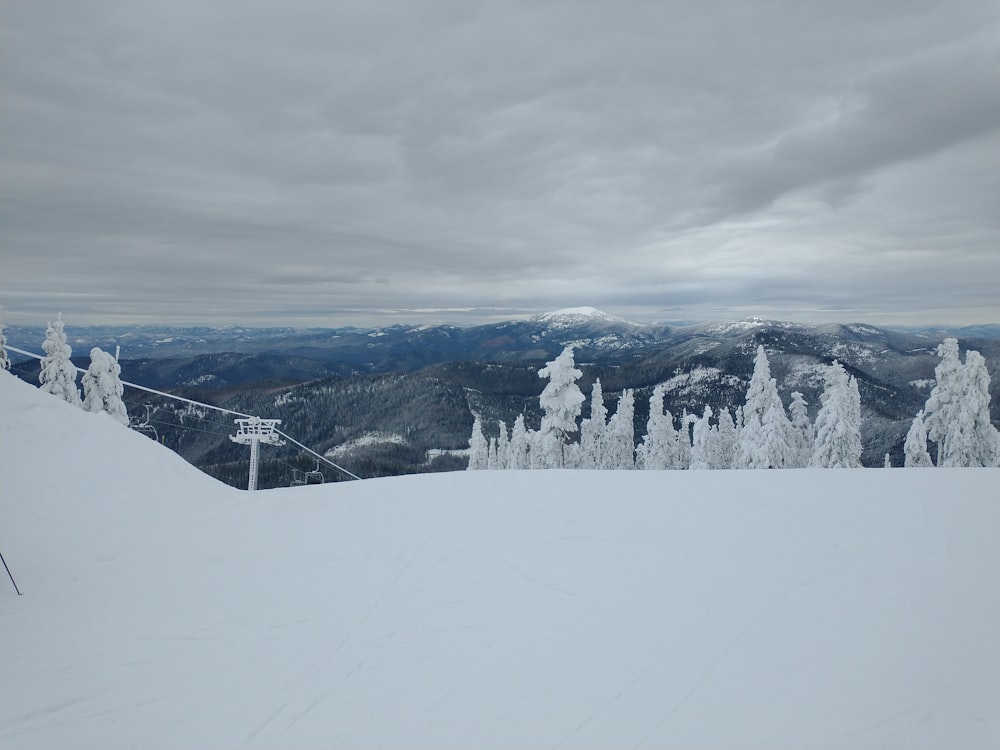 a person on skis standing on top of a snow covered slope