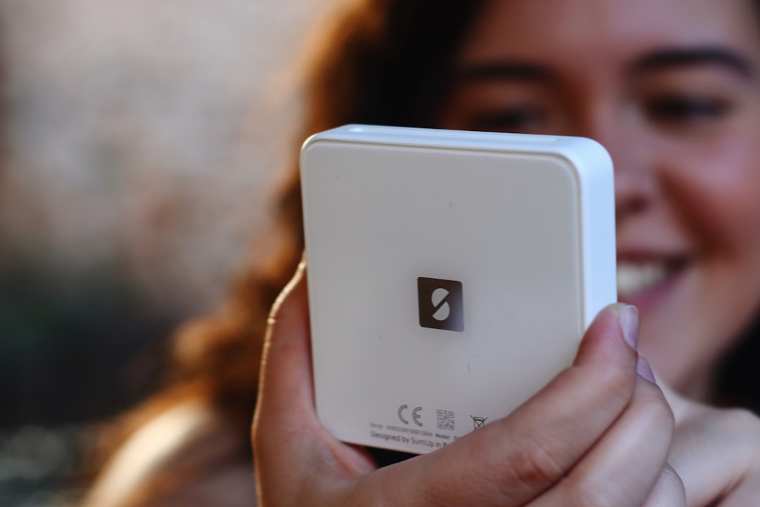 a close up of a person holding a cell phone,