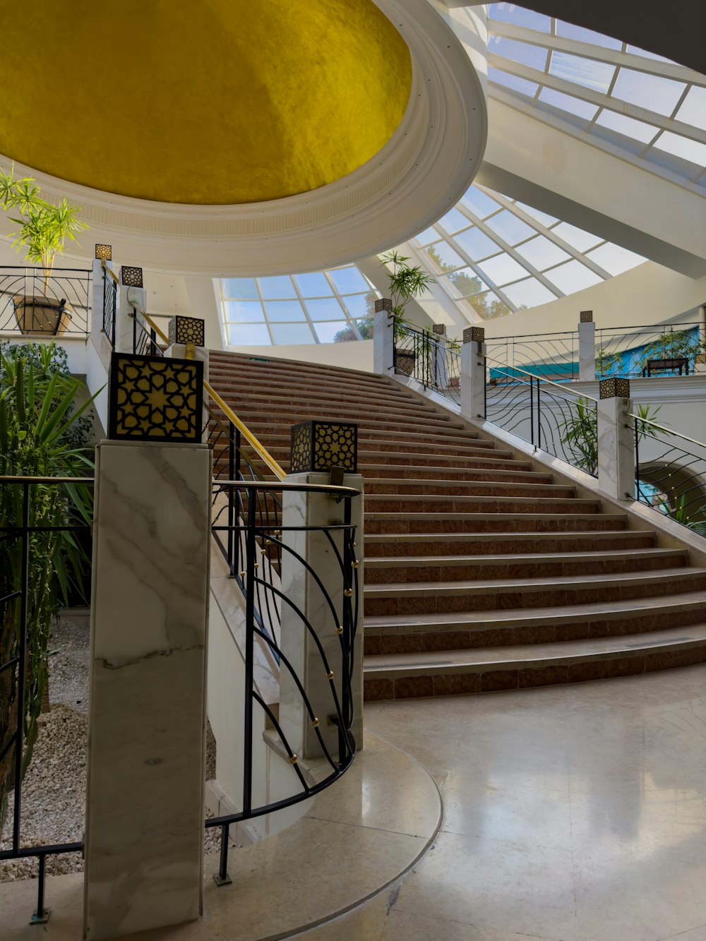 a staircase in a building with a skylight above it