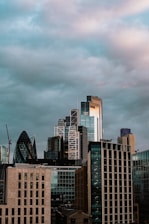 A city skyline partially covered by a futuristic dome with dark clouds outside.