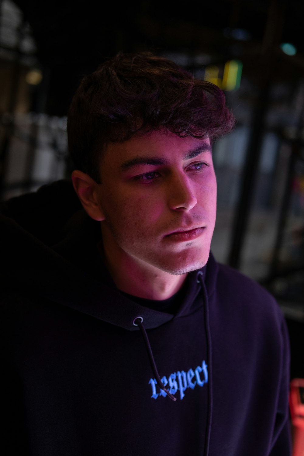 a young man wearing a black hoodie with the word respect on it