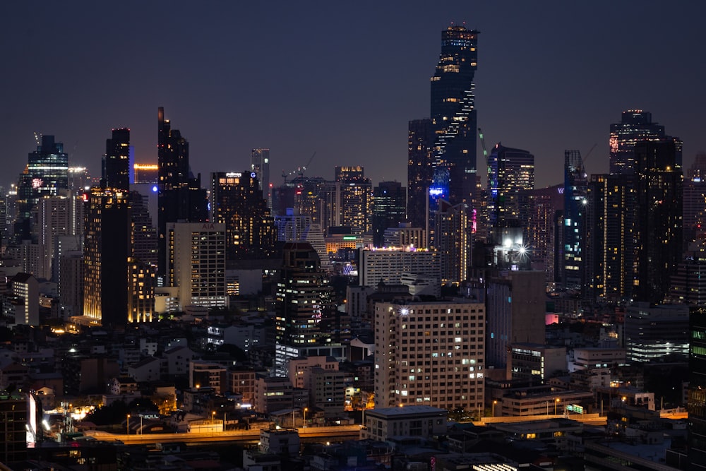 a city at night with a lot of tall buildings