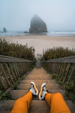 a person with their feet up on a set of stairs