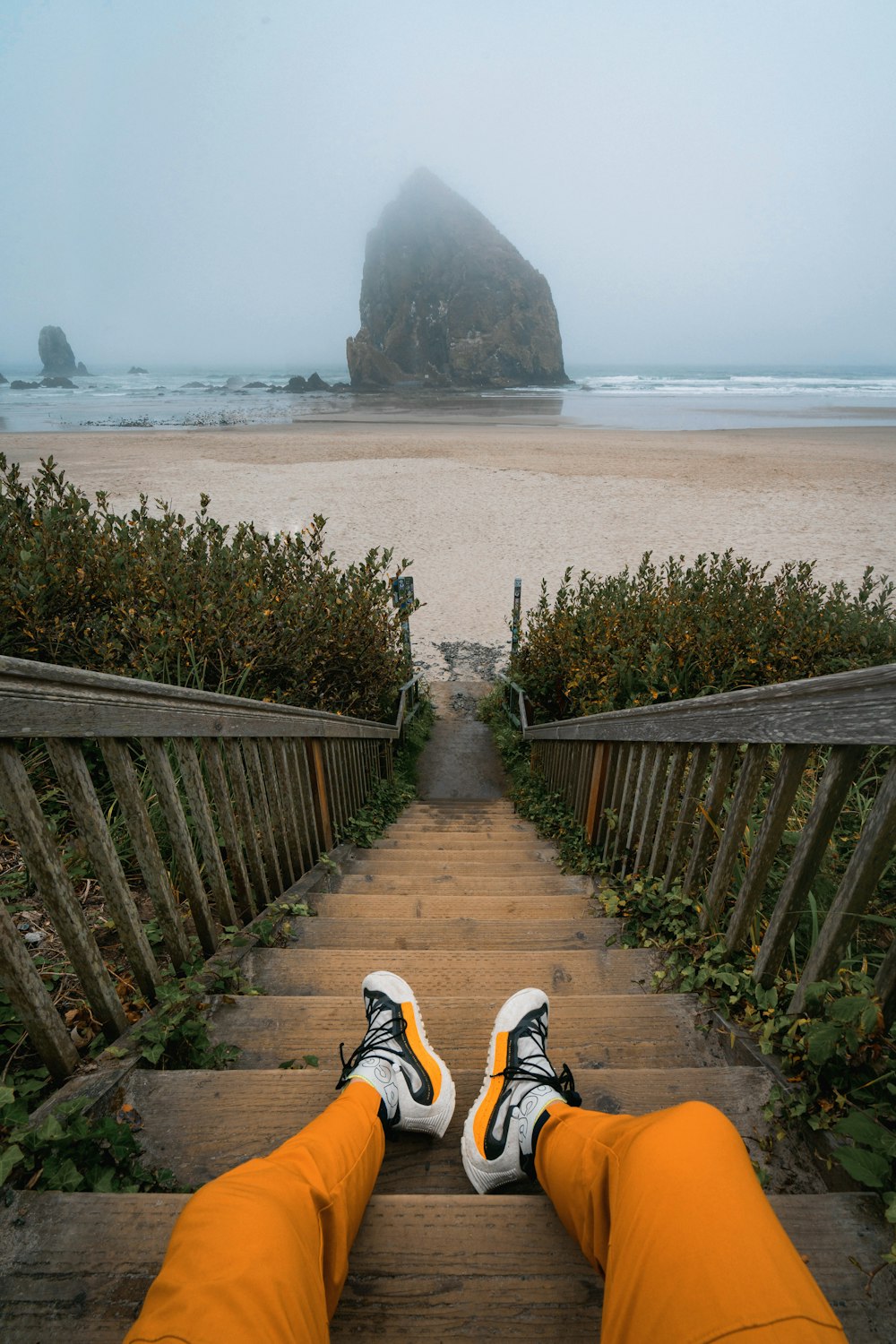 a person with their feet up on a set of stairs