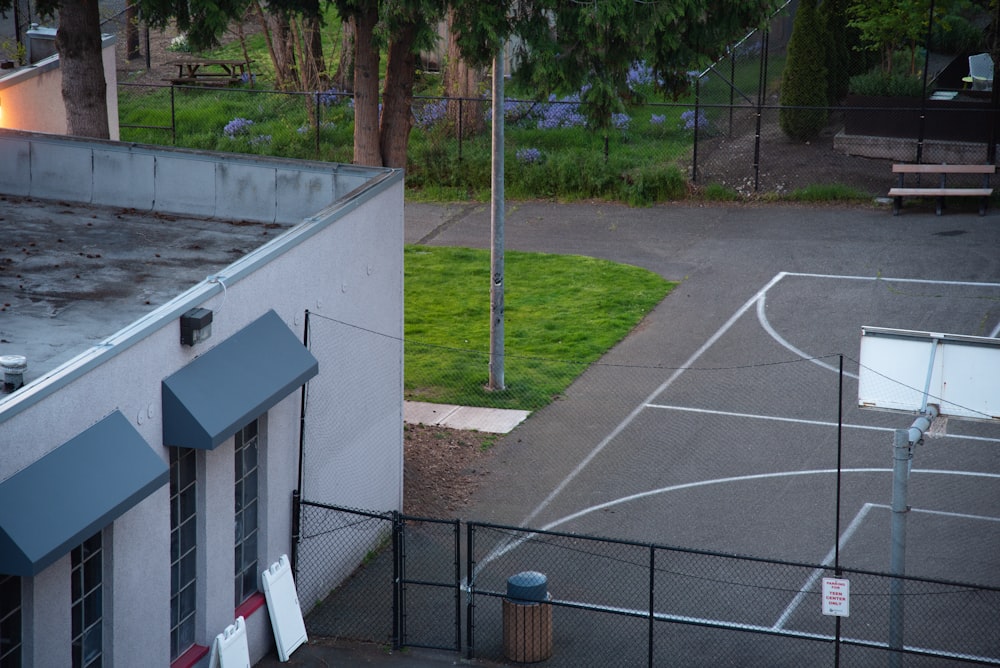 a basketball court in a parking lot next to a building