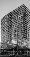 Urban mixed-use building with glass facades during daytime.