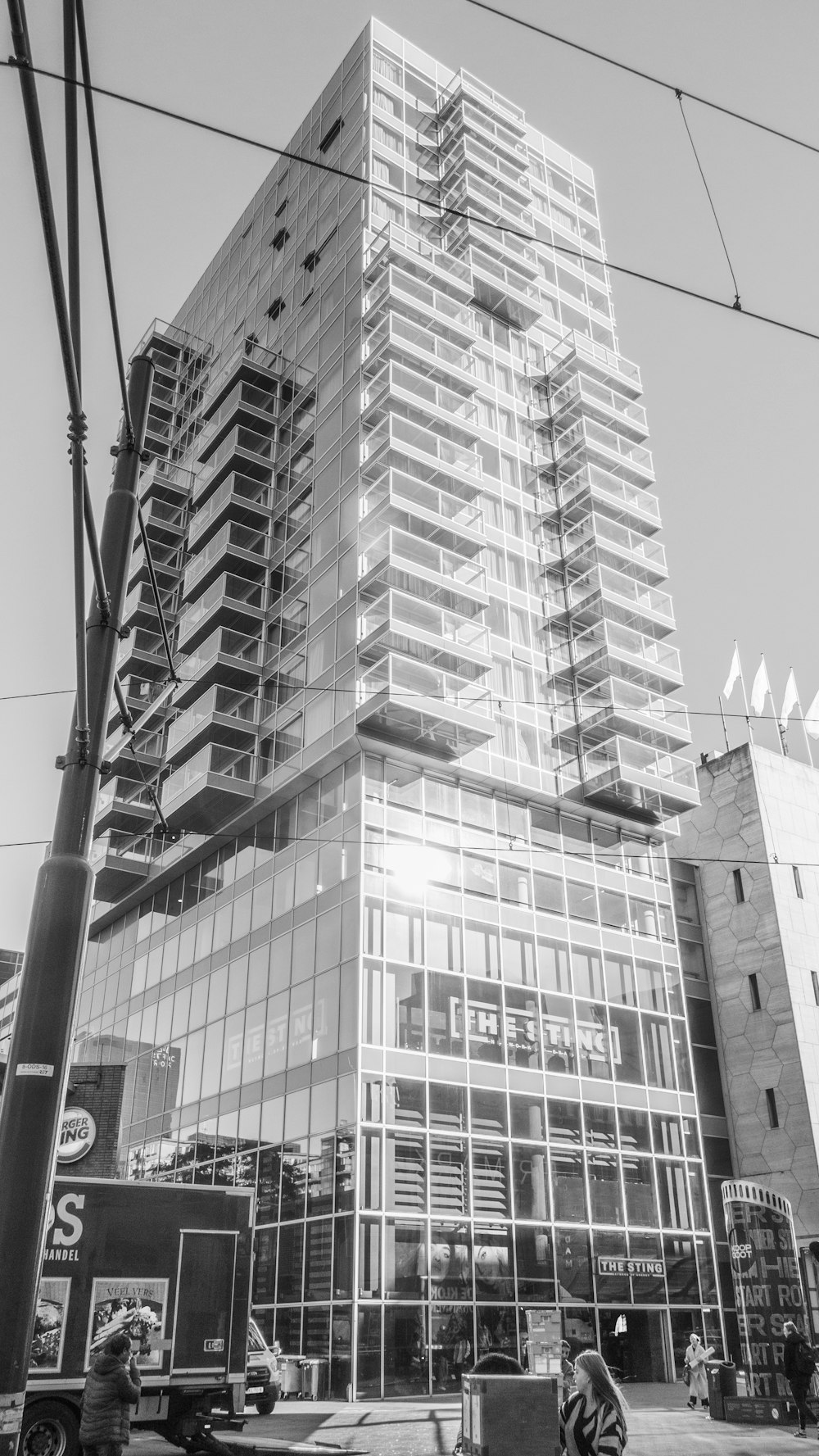 a tall glass building sitting next to a street