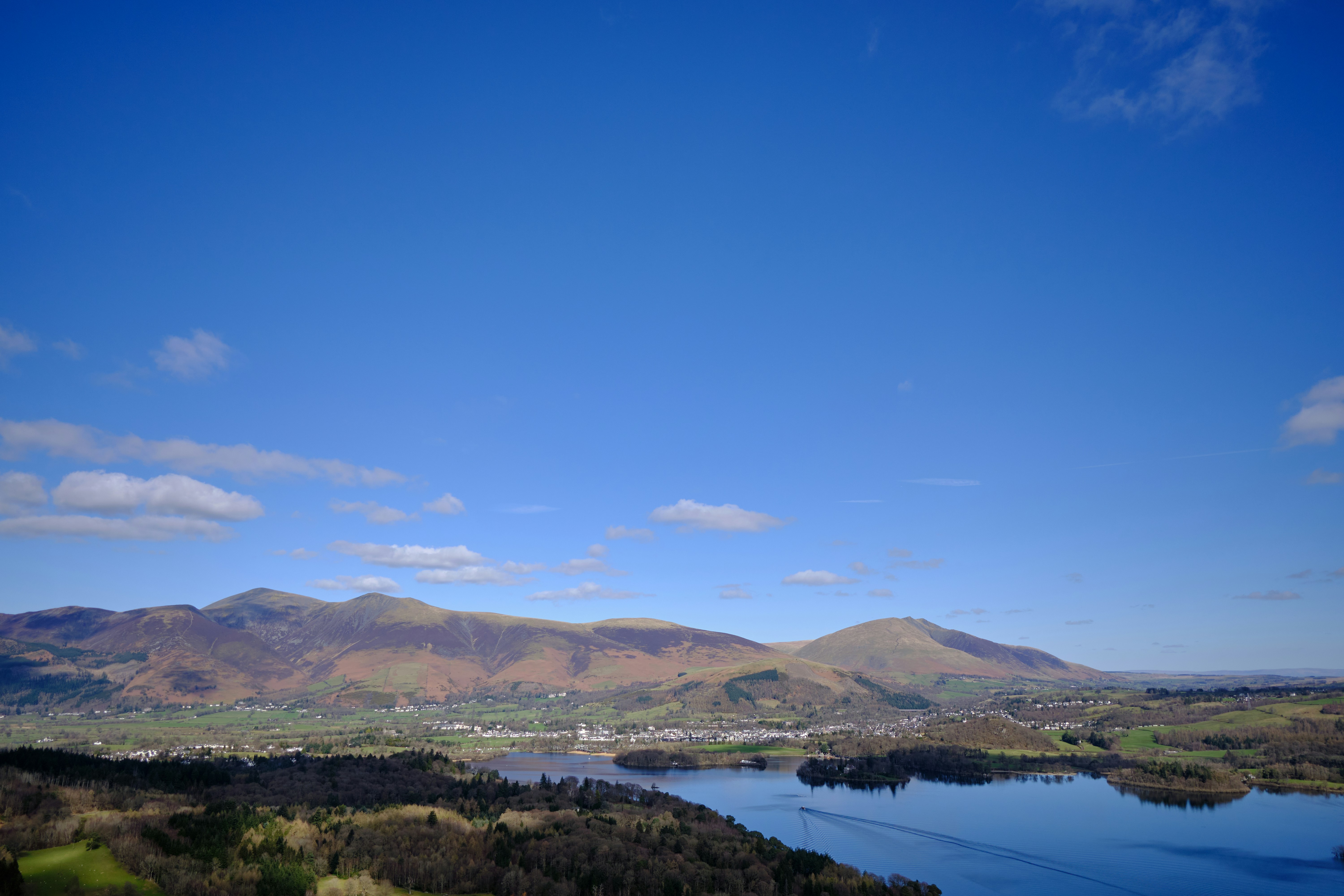 a scenic view of a lake surrounded by mountains