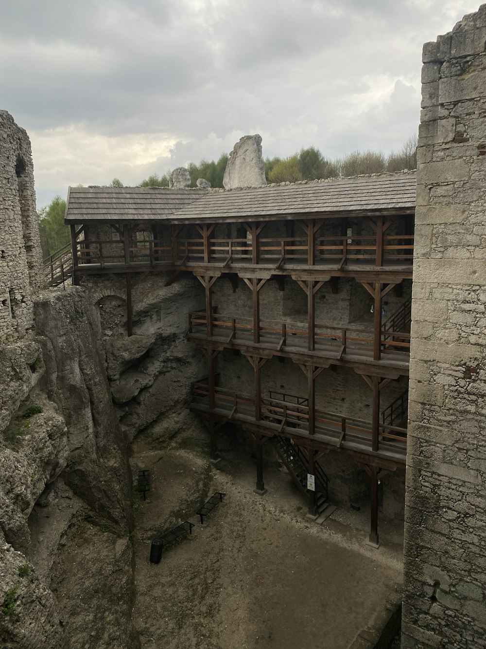 an old building with a stone wall and a wooden balcony