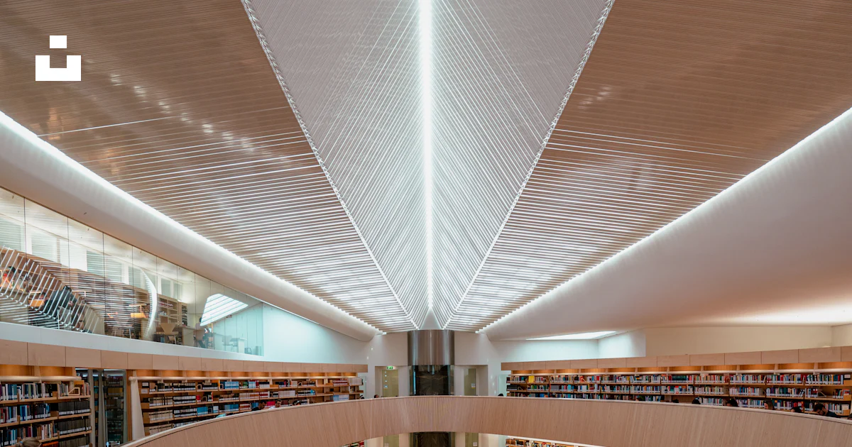 The interior of a large library filled with lots of books photo – Free ...