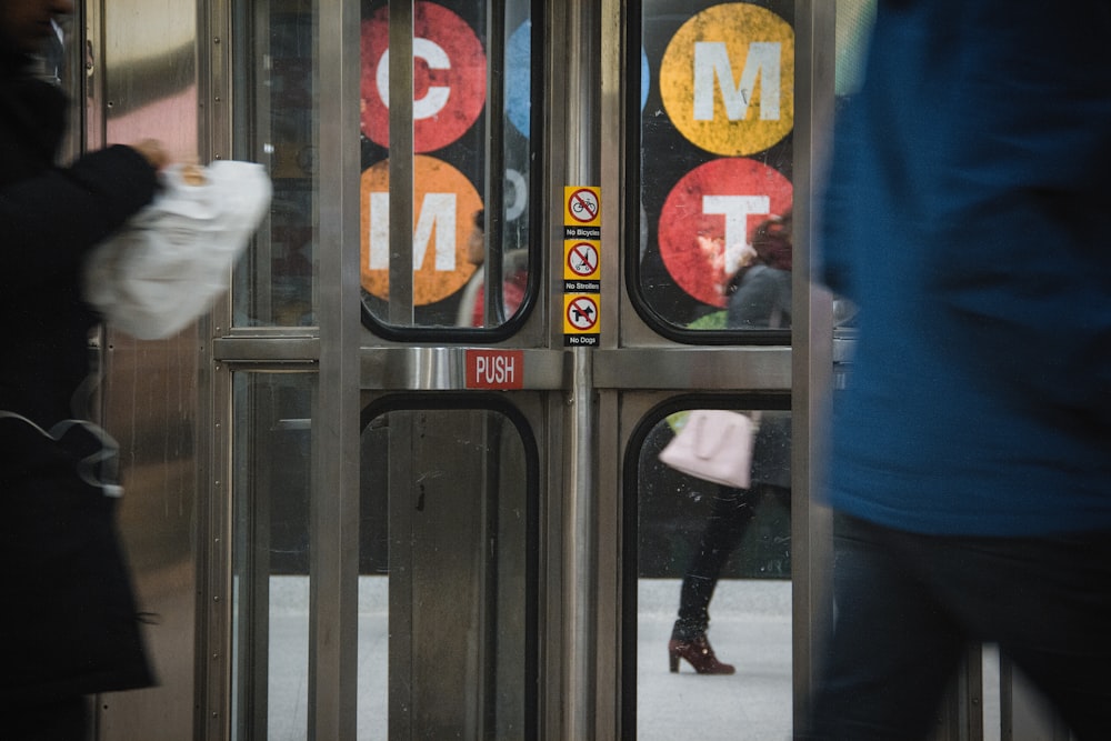 a person walking by a door with a sign on it