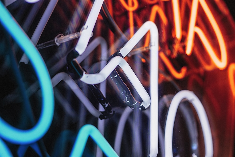 a close up of a neon sign on a wall