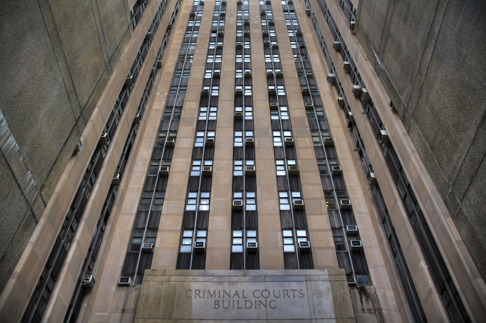 a tall building with windows and a sign on the side of it