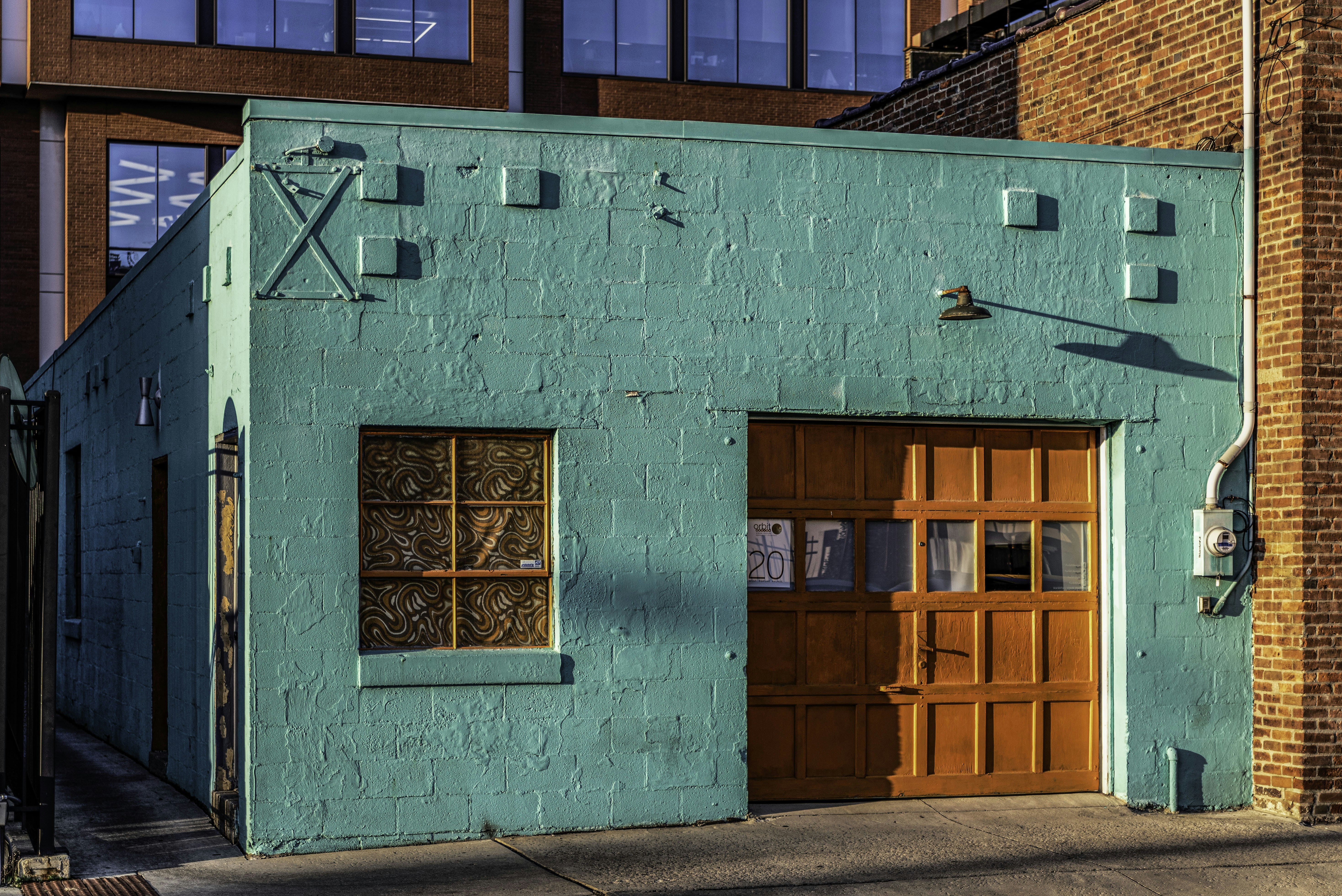 A blue building with a wooden door and windows photo Free Short north