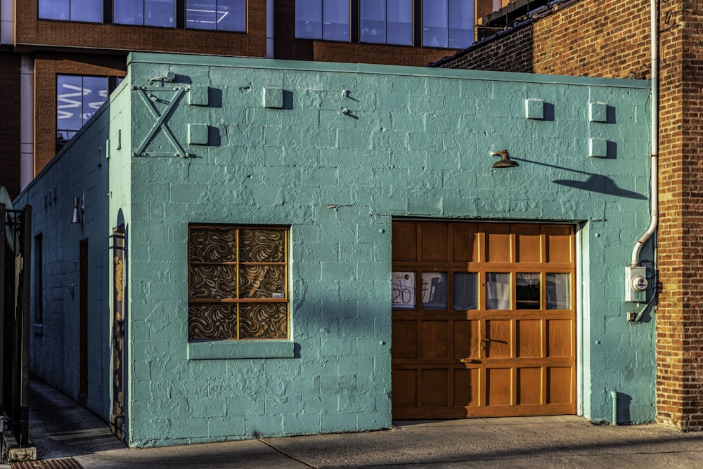 a blue building with a wooden door and windows