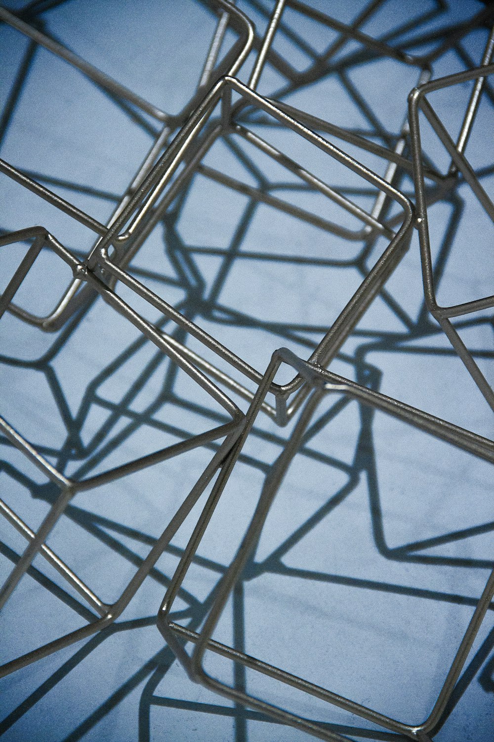a close up of a metal structure with a blue background