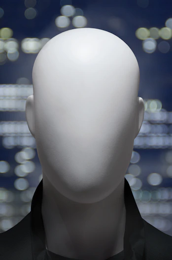 a white mannequin's head in front of a cityscape