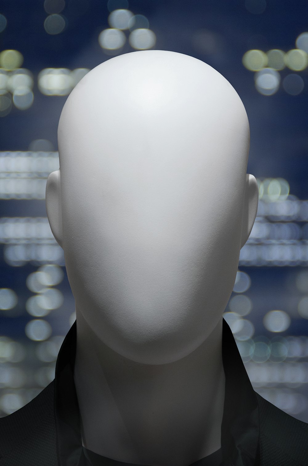 a white mannequin's head in front of a cityscape