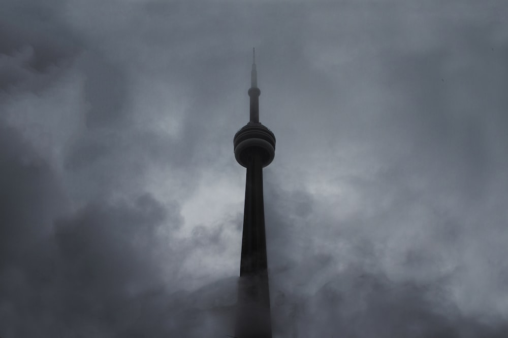 a very tall tower with a very cloudy sky behind it